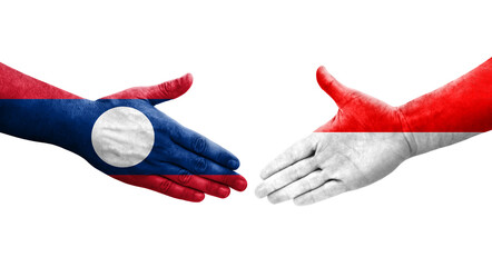 Handshake between Indonesia and Laos flags painted on hands, isolated transparent image.