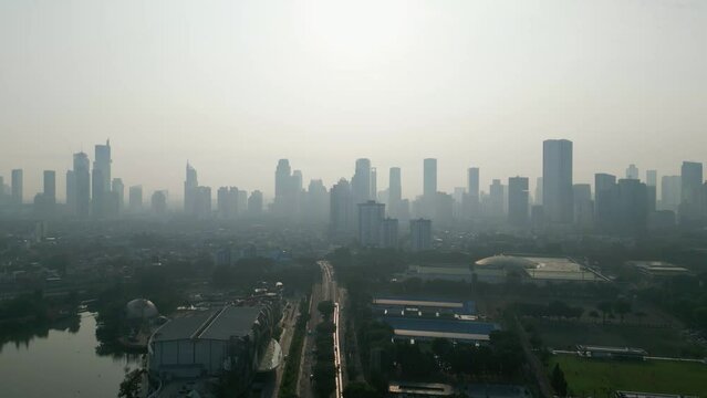 Highway with silhouette of cityscape at morning