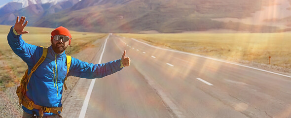 hiker with backpack on the highway hitchhiking, travel activity trip