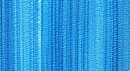 Close up texture of natural weave cloth in dark blue or teal color. Fabric texture of natural cotton or linen textile material. Seamless background.