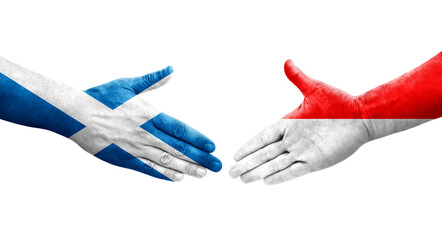 Handshake between Indonesia and Scotland flags painted on hands, isolated transparent image.
