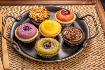 Egg Tart or Baked Cheese Tart in various flavors, purple potato, chocolate, vanilla cream, lemon, green tea and almond cream.