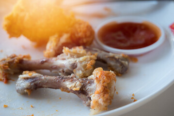 Chicken bones in the white dish