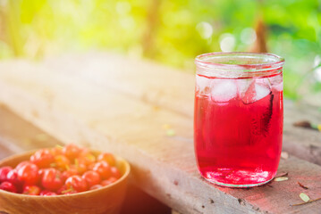 Glass of sour cherry juice with fresh red cherries, Cherry juice, on wood background, red drink, High vitamin C and antioxidant fruits.