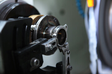 Production of bearings. A machine for processing parts for bearings. Photos without people in a real factory. Selective focus.