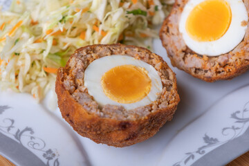 Homemade English Scotch Eggs Wrapped in Sausage close up 