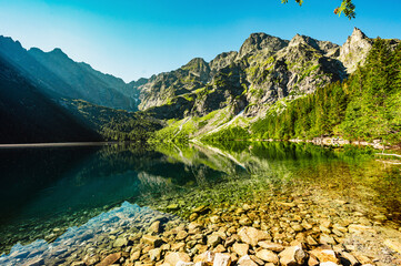 Tatra National Park in Poland. Famous mountains lake Morskie oko or sea eye lake In High Tatras. Five lakes valley - obrazy, fototapety, plakaty