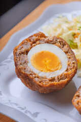 Homemade English Scotch Eggs Wrapped in Sausage close up 