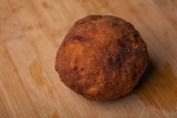 Homemade English Scotch Eggs Wrapped in Sausage close up 