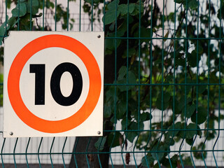 10 kmh speed limit 10mph car kph road sign panel on street city on the town road