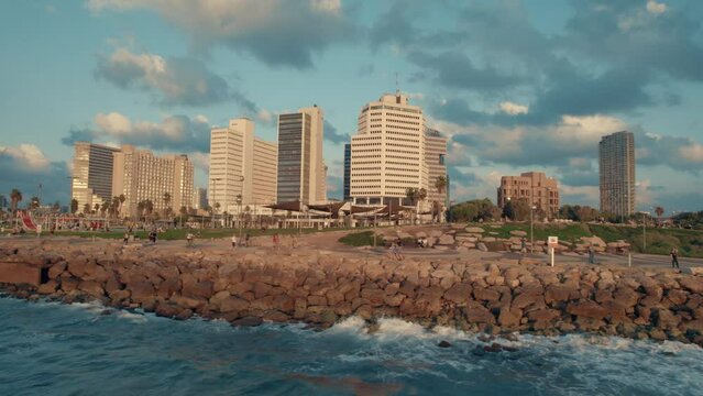Aerial footage of Tel Aviv-Yafo skyline + coastline, Israel - October 14, 2022 -  hotels, buildings and people #008