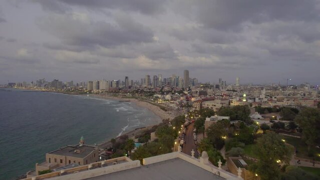 Aerial footage of Tel Aviv-Yafo skyline + coastline, Israel - October 14, 2022 -  hotels, buildings and people #017