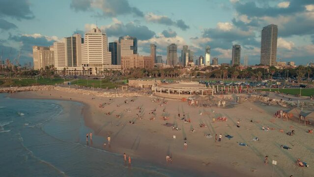 Aerial footage of Tel Aviv-Yafo skyline + coastline, Israel - October 14, 2022 -  hotels, buildings and people #007