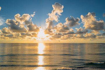 Sea sunset with cloudy sky and sun through the clouds over. Pacific ocean. Clouds Ocean and sky background, seascape.