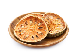 dry Indian bael fruit in wood plate isolated on white background. Indian bael fruit in wood plate isolated. group of Indian bael fruit isolated                                                  