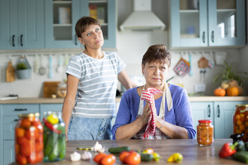 Two women in the kitchen - obrazy, fototapety, plakaty