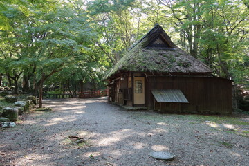 A Japanese traditional house with a thatched roof in Nara-koen Park in Nara City in Nara Prefecture in Japan 日本の奈良県奈良市にある奈良公園の日本伝統的茅葺き家屋