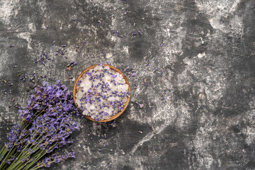 Obraz na płótnie Canvas Lavander salt with natural spa products and decor for bath on gray background. Flat lay