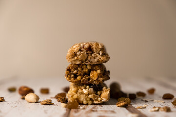 Various energy bars with granola chocolate in a row with scattered nuts, cereals and dried fruits,...