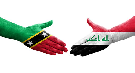 Handshake between Iraq and Saint Kitts and Nevis flags painted on hands, isolated transparent image.