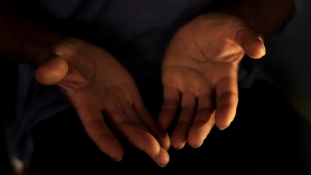 praying to god with hands together Caribbean man praying with dark background stock video