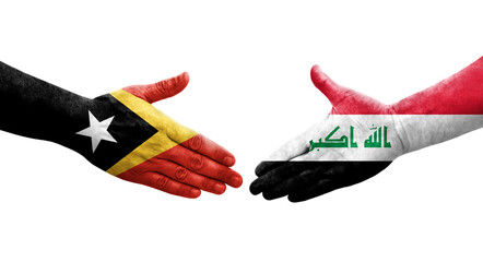 Handshake between Iraq and Timor Leste flags painted on hands, isolated transparent image.