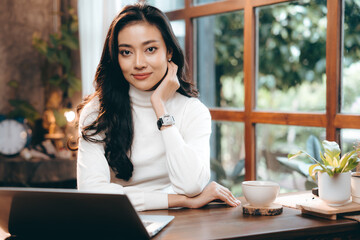 portrait of young business entrepreneur woman lifestyle, professional freelance businesswoman having smile and happy to work using computer laptop on online cyberspace technology, Asian beautiful girl