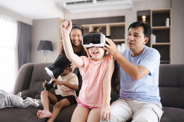 children family with mother and father home, happy and smile with virtual reality goggles...