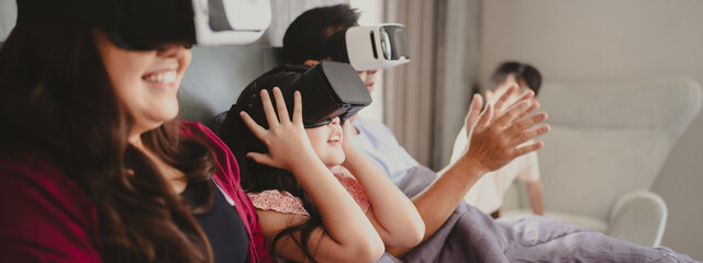 children family with mother and father home, happy and smile with virtual reality goggles technology together, person leisure lifestyle to having fun with digital video game by wearing headset