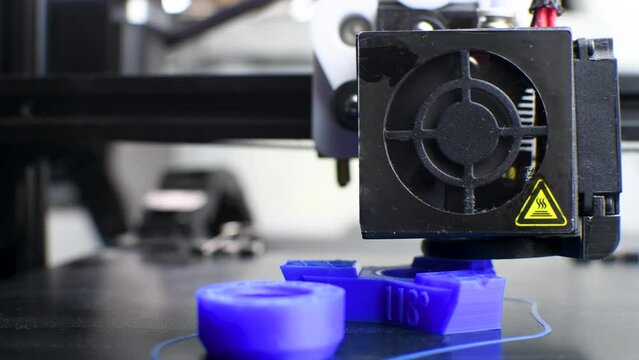 The 3D printer printed blue plastic model. modern technology