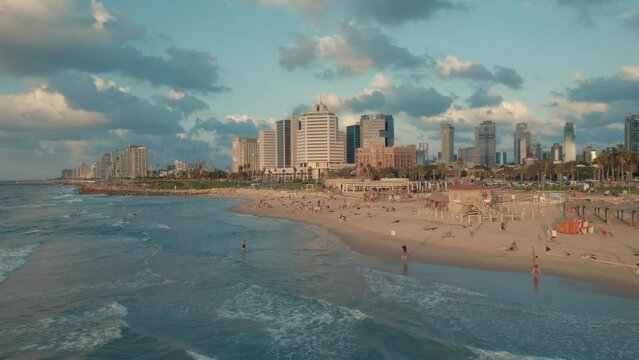 Aerial footage of Tel Aviv-Yafo skyline + coastline, Israel - October 14, 2022 -  hotels, buildings and people #006