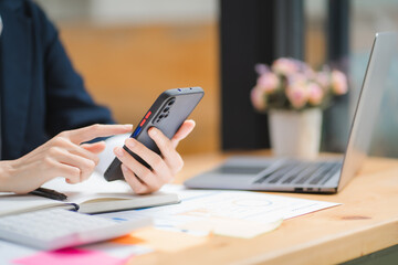 Fototapeta premium Young asian businesswoman beautiful charming smiling and talking on the mobile phone in the office