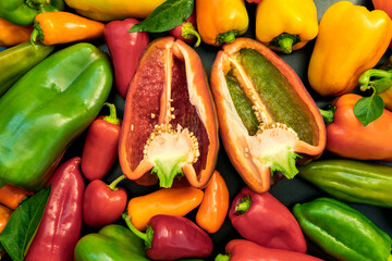 Red, green and yellow fresh bell peppers. Vegetable background from sweet pepper, paprika. Harvest from the garden. Pepper cut. View from above.