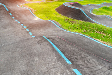 Off-Road Cycling Course.Asphalted bicycle pump track, racing speed track with traffic lines for ...