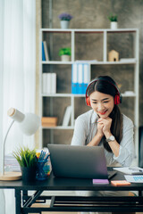Asian woman enjoy listening to music and drinking coffee and laptop computer in the morning