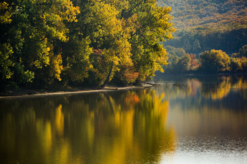 Beautiful autumn nature with yellow trees and reflection in the water