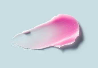 Cosmetic products creamy pink lip balm or hair wax texture smudge blue background	
