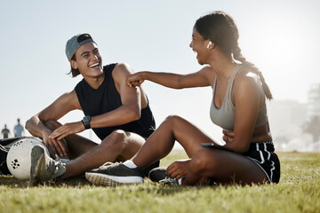 Fitness, friends and soccer grass break by man and woman relax, laugh and enjoy conversation on a...