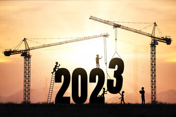 Silhouette engineers working on a construction site To prepare to welcome the new year, cranes and...