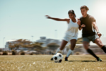 Sport, friends and soccer with man and woman playing on a soccer field, competitive training for...