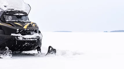 Fotobehang Panoramic background with snowmobile on ice of frozen lake on winter day © alexei_tm