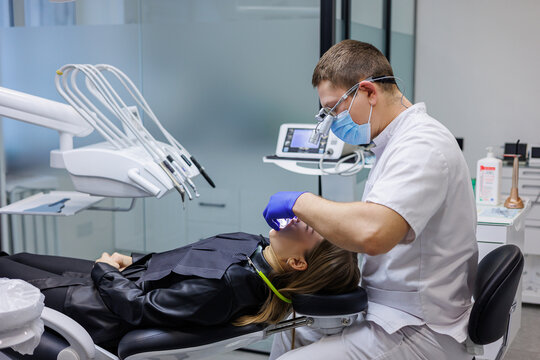 A Dentist Treats A Patient's Teeth. Modern Progressive Dentistry. Dental Office With Tools.