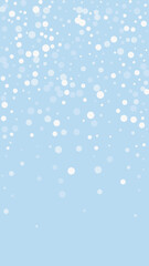 Beautiful snowfall christmas background. Subtle flying snow flakes and stars on light blue winter backdrop. Beautiful snowfall overlay template. Vertical vector illustration.