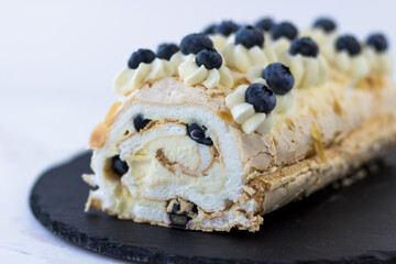 Merengue roll with close-up blueberries. Delicious dessert