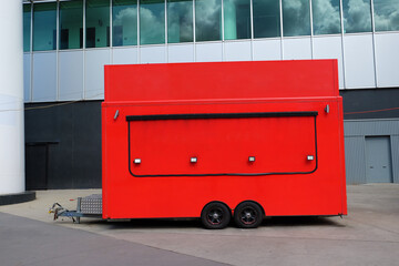 Red fast food trailer at a stadium. Copy space for logo.