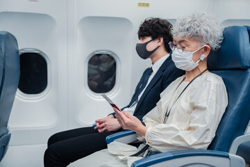 飛行機で旅行をする高齢の女性