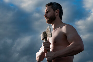shirtless man with axe. athlete man hold ax. brutal man on sky background
