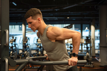 Fototapeta na wymiar sport muscular man do pushups in fitness gym. pushups practicing muscular man in gym.