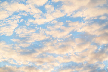 Beautiful blue cloudy shining sky in the evening