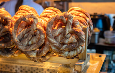 Close up of puff pastry pretzels with brown sugar and cinnamon in a small bakery store. Small...